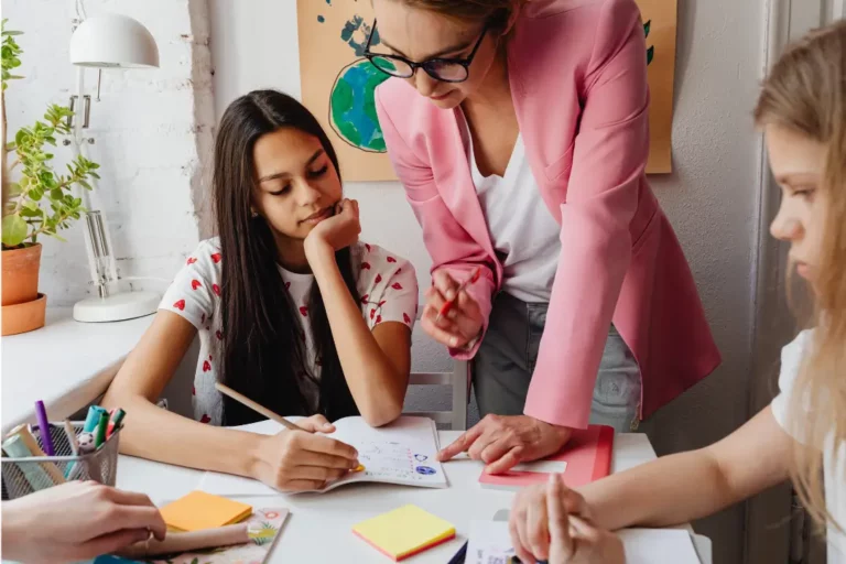 students getting tutored by a teacher