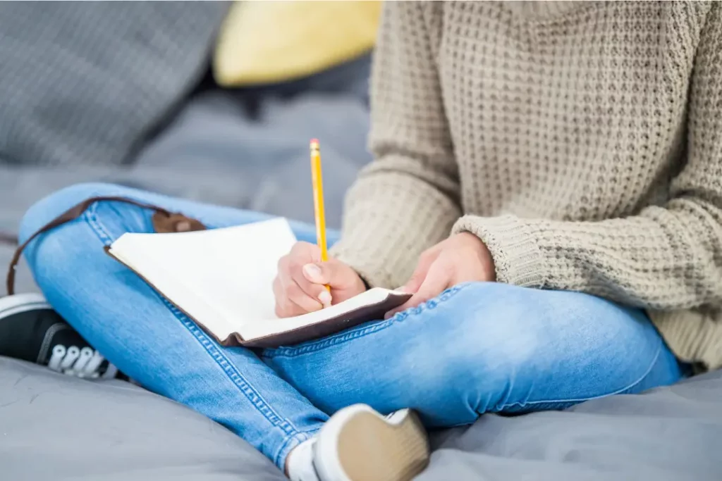 student writing in a notebook