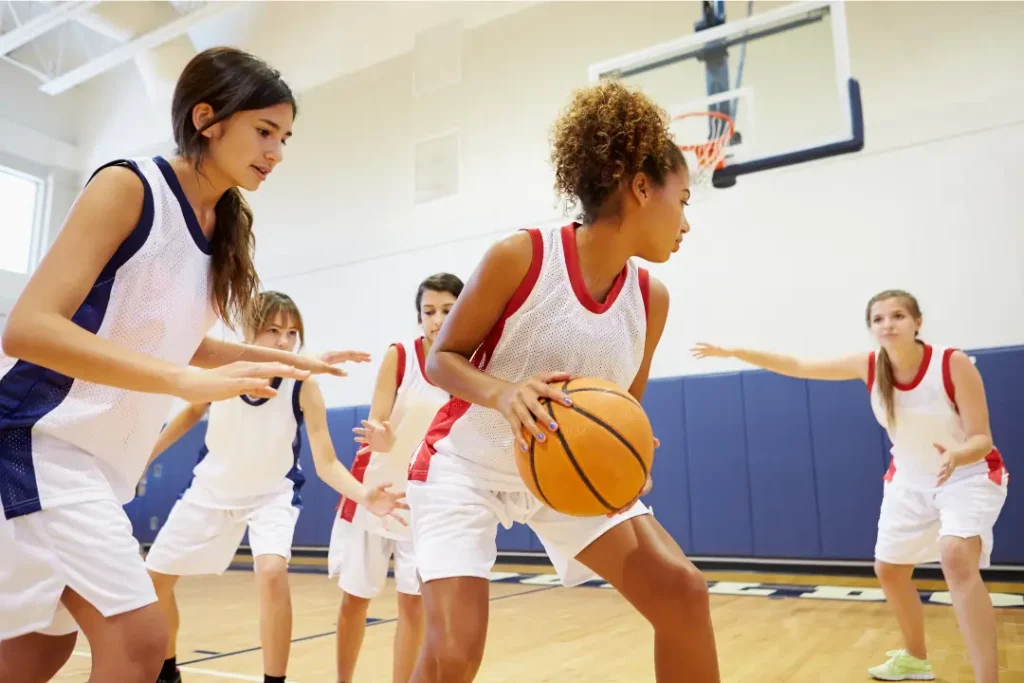 students playing a game of basketball