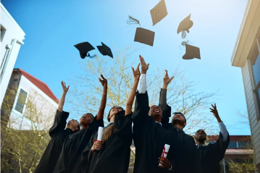 graduating students throwing their caps in the air